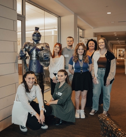 Université de Reims Champagne-Ardenne students posing with the Macon Campus Knight statue.